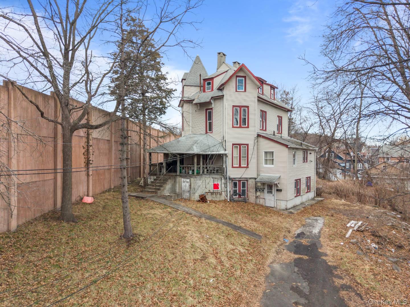 Rear view of house featuring a fenced backyard and a chimney