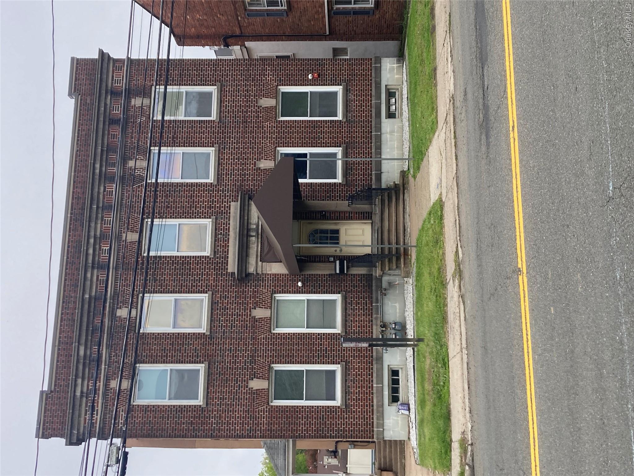 Brick building featuring a prominent entry with an awning