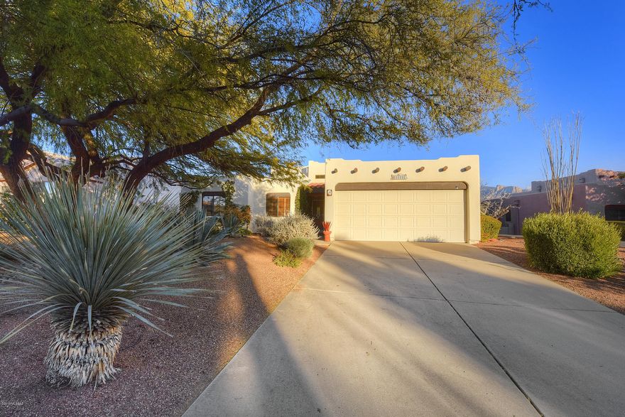 Beautiful views await you from several vantage points inside this one of a kind Southwestern Sante Fe style home located in the heart of Oro Valley. Large East-facing windows throughout the house and spacious (27 x 13) screened in Arizona Room make it a special place to relax & unwind. The high beamed ceiling, faux painting, upgraded lighting accompanied with the beehive fireplace create a warm, dramatic greatroom entrance. The spacious and open floor plan includes Saltillo tile in all high traffic areas with neutral carpet in all bedrooms.  The kitchen features hand-painted decorative tile counters and back-splash.The spacious private lot is abundant with fruit trees including Lemon, Orange, Fig, and Grapefrut.  Polybutylene piping inside the home was replaced with PEX!