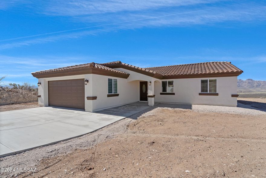 Experience the pinnacle of Rio Rico, AZ, living with this stunning, brand-new construction home. Boasting a thoughtfully designed floorplan, this residence features 3 bedrooms and 2 bathrooms accompanied by a convenient 2-car garage, all situated on an expansive 0.55 acre- acre lot offering picturesque mountain views.  From the moment you enter the home, you'll be captivated by the meticulous attention to detail and the seamless flow of the layout, creating an inviting and functional living space.  Currently, in the active stages of construction, this is projected to reach completion by the end of September 2024.  It promises modern comforts and beautiful finishes throughout.  Imagine waking up to the tranquil beauty of Rio Rico each morning, with the majestic mountains as your backdrop a and ample space to create memories.