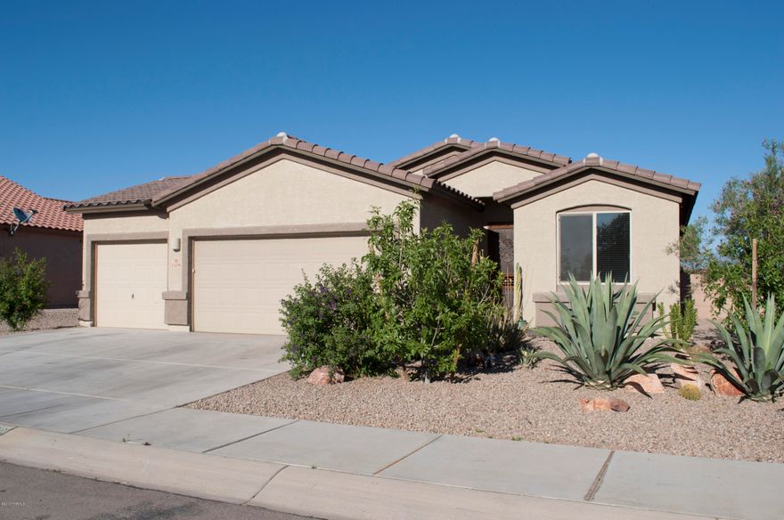 Located in the San Lucas neighborhood, perfectly situated on the very back of the community on a premium lot with 25 miles of state land directly behind its walls. The views of the sprawling mountains will never be blocked by another build and the picturesque desert mountains make this home feel secluded. Boasting a 3 car garage that has been updated into a hobbyists dream with a fully plumbed slim mount swamp cooler, 220 plug, extra wiring and extra LED lighting- this garage is meant to be used for more than car storage! The perfect house for a furry family, the dog door leads to a separated, graveled, yard just for the dogs, leaving the bohemian garden paradise just for you to enjoy. Fully landscaped and drip irrigated the back yard, covered patio, updated master and more.