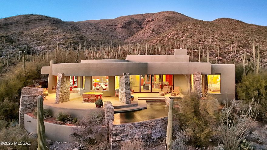 Stunning architecturally designed home by award winning architect, Kevin Howard, known for dramatic design, graceful curves, combining natural stone, glass & wood throughout creating an ambiance of bringing the indoors & outdoors together in a seamless transition. Located in prestigious gated Sabino Springs on over 1 acre.  2BDs + Executive Office/3rd Bedroom.  40'x26 ' Great Room with 14 ft. high ceilings, dramatic stone fireplace, beautiful travertine tile floors, 20' long sliding doors to provide the open-air experience to the incredible extended rear patio. A chef's gourmet island kitchen features beautiful cherry cabinets, gorgeous granite including Viking gas cook top, Subzero Refrigerator/freezer, microwave, dishwasher, under counter lighting, pantry, lovely breakfast area with walls of windows, 8 ft. Alder doors throughout, zoned air-conditioning, 3018 sq.ft., natural stone excavated from the property. Primary bedroom w/luxurious bath featuring cherry cabinets, double vanities, granite countertops, soaking tub, wonderful steam shower, large walk in closet & private entry to the rear patio. Second bedroom features en-suite bath, walk in closet and private entry to the back patio. The home office/3rd bedroom is a perfect combination of luxury & functionality w/wood built-ins, semi-circular desk, ample cabinets & bookcases. Enjoy the gracious resort outdoor living complete w/ gas heated negative edge pool &  spa, fabulous outdoor fireplace, gas grill,1200 sq.ft. of covered lounging area, oversized 2 car garage w/ workshop, and additional parking. Overlooking the majestic golf course at Arizona National Golf Course, a forest of sahuaros & city views, you will be exhilarated by the natural beauty from every room.