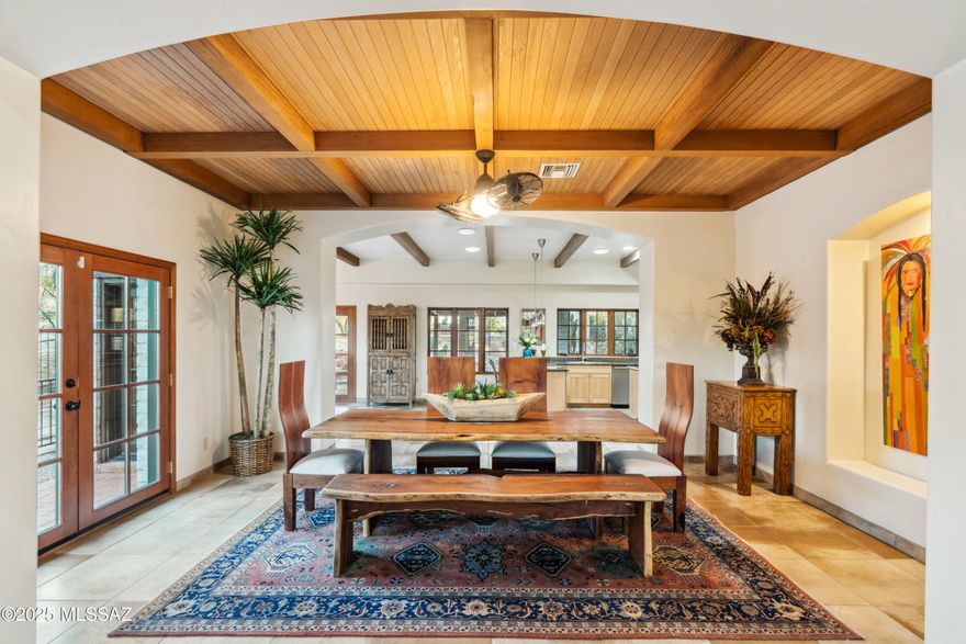 Set within the storied Harold Bell Wright Estates, 6510 E Marta Hillgrove is a rare offering that combines architectural heritage with refined living. The main residence, a southwestern contemporary custom built in 1995, features 3,745 square feet of elegant space. Upon entering the gated property, guests are greeted by ample parking adjacent to thoughtfully designed water features with Koi and goldfish. From there, a decorative wrought iron gate leads into a tranquil courtyard. Inside, soaring ceilings with exposed wood beams create a light-filled atmosphere, while the living room's fireplace and formal dining room invite both relaxation and entertaining. The kitchen is designed for culinary enthusiasts, with a large island, double ovens, stainless steel appliances, natural maple cabinetry, and granite countertops.
The estate includes a guest house and a pool house, built circa 1922, adding flexibility and bringing the total living area to 5,090 square feet. Local lore suggests Helen Keller stayed in the guest house during her visits to Tucson, adding a unique historical dimension. Each bedroom in the main house offers a walk-in closet and en-suite bath, while the primary suite features a large walk-in closet and French doors that open to a covered patio with views of the Santa Catalina Mountains.
Set on 1.15 acres, this property offers privacy, mature desert landscaping, and expansive covered patios for enjoying the outdoors. A four-car tandem garage, dedicated carport, and generous storage meet practical needs, while the absence of an HOA and a central location provide both convenience and seclusion. 6510 E Marta Hillgrove is a masterful blend of design, comfort, nature, and history.