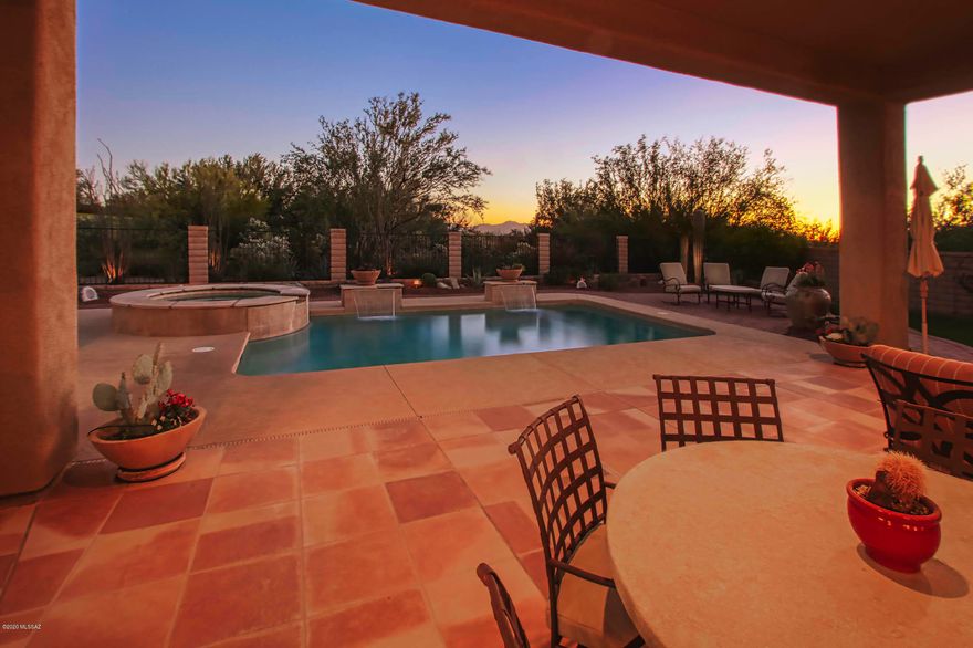 Exquisite home on The Gallery golf course. This popular floor plan in gated Dos Lagos at Dove Mtn is timelessly appointed from travertine flooring to the Cantera stone FP in the Great Room. A chef's dream kitchen with ample granite countertops, 5 burner gas cooktop & stainless appliances including a warming drawer. Great room has built-in entertainment center and wet bar. Large Master bedroom with bay window sitting area & access to backyard. Master Bath feels like a spa with large soaking tub and glass block shower. Enjoy the AZ outdoors in the resort-like backyard that backs up to the golf course & has a built-in BBQ, refreshing pool, in-ground spa, covered patio and of course the beautiful sunsets we are famous for.
