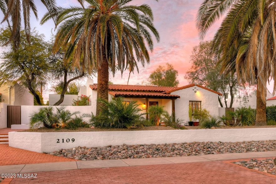 Spanish Mission 1929 home in Sam Hughes offers a blend of historic charm and modern amenities creating a comfortable residence. This property is a charming Spanish Mission-style home built in 1929, located in the heart of Sam Hughes. Here are the key features of the property: This home is a spacious, 2535 square feet.  It Offers 3 bedrooms and 3 bathrooms. The master bedroom is large and has a private patio, along with a newer en-suite bathroom. There are two other large bedrooms which share a completely remodeled bathroom with a deep claw foot bathtub. High ceilings in the living room and separate family room with 10' beamed ceilings, Living room fireplace, and hardwood floors, cozy and elegant.  The kitchen has been remodeled with newer Thomasville cabinetry and Dekton countertops. There's an eat-in area and an outdoor patio connected to the kitchen, providing a nice space for dining and relaxation.
The separate, large family room offers wood plank & beamed ceilings. The house features a formal dining room with butler's pantries, adding to the classic charm of the property. The property boasts a huge walled, relandscaped backyard, It features a newer pebble tech pool, Belgarde brick patios, creating a perfect outdoor oasis.  2 on-demand water heaters, upgraded plumbing, lighting fixtures, doors, windows, and electrical systems. There's also off-street parking available. This home is on the National Historic Register and eligible for a reduction in taxes for owner occupants.  Off street parking!
Walking distance to UArizona, Modern Street Car, Restaurants, parks and more!