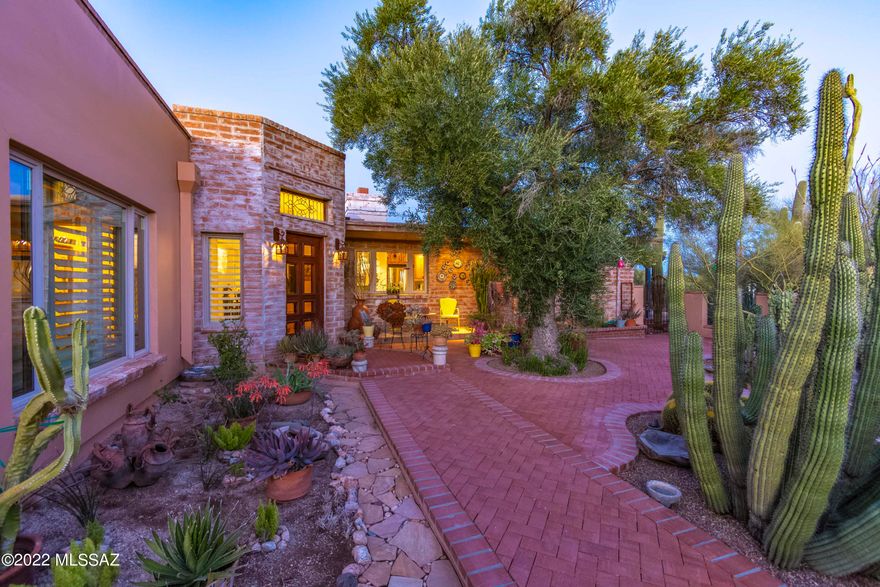 Enjoy Beautiful Mountain VIEWS from almost every window! Located in coveted Casas Adobes Area. A Perfect Blend of Mid-Century Charm and Modern Function. Owners renovated the original burnt adobe  home & added a Luxurious Master Retreat.  Sited on a 1.37 acre rich with desert vegetation. A long aggregate driveway leads to custom wrought iron gate, into a space alive with lush landscaping & walkway to the custom front door. A huge window framing Pima Canyon graces the expansive Great Room. The Master Suite has His & Hers walk-in-closets. Master Bath offers custom vanities, marble shower (2 shower heads) towel warmer, air jet tub, Sauna, high-end granite & bath fixtures. Family room opens to the covered patio, while multiple windows bring-in the outdoors and the VIEWS! OWNER/AGENT Kitchen features granite counters, wood cabinets, prep sink, Dacor Oven, Fisher & Paykel gas cooktop and dishwasher. Adjacent to kitchen there is a space with plumbing, would be a perfect Butler's pantry. En-suite 2nd bedroom has sitting area, many windows and a Great View. Third bath just re-done. 760 sq. ft. garage has large workshop space, 2 storage areas. Other features include travertine & concrete floors, fireplace, plantation shutters. Citrus trees, raised vegetable garden. Burnt Adobe construction. This home is full of character and charm. No HOA plenty of room for a guesthouse, another garage. Huge windows overlook the Catalina Mountains. Located within close proximity to shopping and fine/casual dining, near Casas Adobes shopping Center.