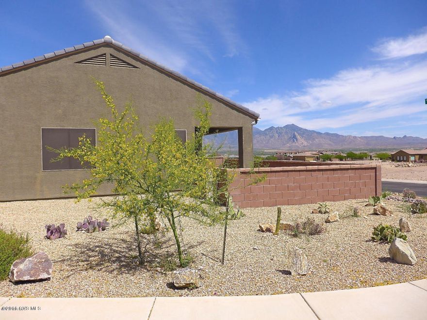 If views at a great price are important to you then this is one you'll want to put at the top of your list. Situated on a quiet corner lot in Canoa Ranch this lovely home is loaded with upgrades. Outstanding floor plan has a great room with a large pass through to the kitchen, tile in all the right place, gas range, custom backsplash and so much more. While the interior is definitely special, wait until you step into the backyard. One look at that panoramic view of the Santa Ritas and you'll want to call it home!