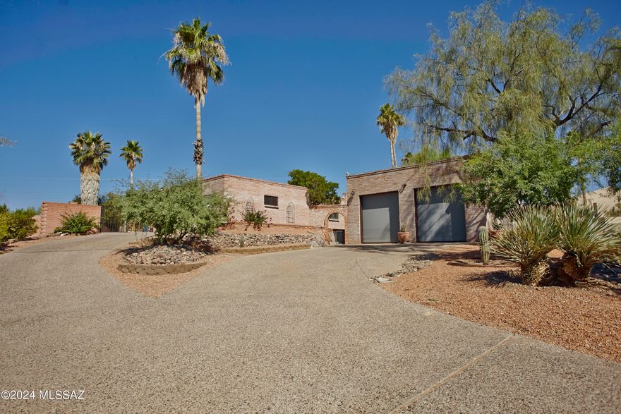 This home exudes Southwestern charm with its rich, warm tones and distinctive features. The floors are adorned with traditional Saltillo tiles, their earthy, terracotta hues adding a rustic, handcrafted feel. 
New remodeled kitchen/family rooms created a wonderful warm open floorplan. Kraft made quartz counters, ss appliances.. One br, has Murphy bed & separate sitting area, perfect for generational living or office.The dining room w/fireplace. Step outside the expansive yard with pool/spa, & extended yard that could be used for so many things, basketball, volleyball, pickleball court. 2 RV size garage is a workshop dream! Has its own a/c, air compressor, wire for high powered tools. Plenty of storage, storage room accessed from back yard, 
Cabinets in garage, in RV there are shelves for upper storage. ladder to access them will convey. Spa is currently not heated and will be sold as is.