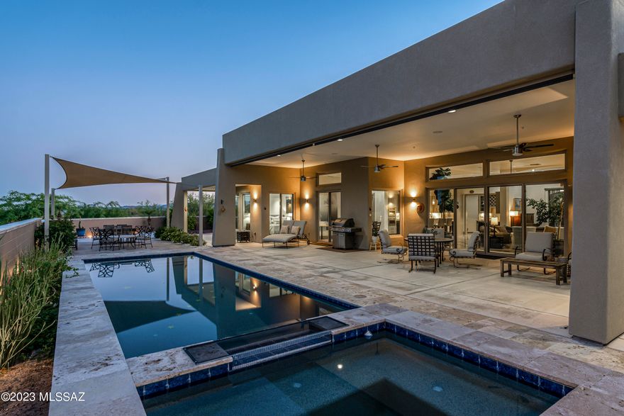 You will be greeted by Iron Double Entry Doors of this 2017 Custom-Built Estate on 3.3 acres in desirable Oro Valley. 11 ft. ceilings & energy efficient lighting create an airy feel. The glass gas FP & gourmet kitchen with Jenn Air appliances, steam oven, wine cooler, wet bar & butler pantry, awaits. 2 east-facing masters with huge closets, rainwater shower heads, dual vanities & a free-standing tub. Enjoy separate 3rd bed with hall bath & extended closet. Breathtaking Catalina views & desert landscapes from the back patio with roll-down screens, travertine pavers,heated pool & jetted spa. Tortolita & Tucson ranges in front delight. Garage with 10x10 RV space, epoxy floor & air compressor. Unwind to desert sounds & wildlife. Enjoy desert blooms & strolls on aptly named Desert Splendor Ct.
