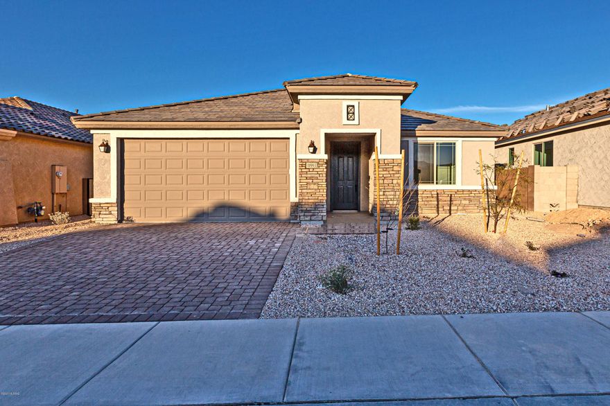 Tangerine Ridge is an all single-story gated community, located near Twin Peaks and Tangerine Rd.  Owner's bath features glass walk in shower, granite countertops in kitchen with Linen Cabinets with dual sinks and huge walk in closet.  Kitchen offers modern appointments such as chef kitchen with stainless steel gas appliances, granite countertops and pendant lights over the island.  The flooring throughout is 12 x 24 porcelain tile in all areas except bedrooms.  Other upgrades include 2 tone paint and pavers on the driveway.