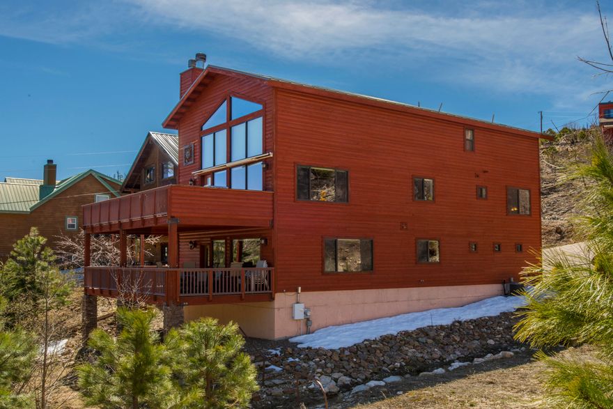 Beautiful Luxurious mountain cabin loaded with amenities with year around access.This is a 4 bedroom 3 bath with a 2 car garage with its own work station. Mud room in entry way for snowy days.Large open living room with electric window coverings.Master suite with its own fireplace and an open loft on top floor for possible office space.Master bath with a jetted bath tub and separate shower.Large media room on the bottom floor with a full wet bar and its own deck.2 Large Trex decks for easy maintenance and a built in gas BBQ on main floor deck,perfect for gathering on beautiful mountain days.Cabin has an alarm system,surround sound,central vac.Located behind the Living Rainbow,perfect location for walking distance to the village and Marshalls Gulch.Come up and check out this stunning cabin!