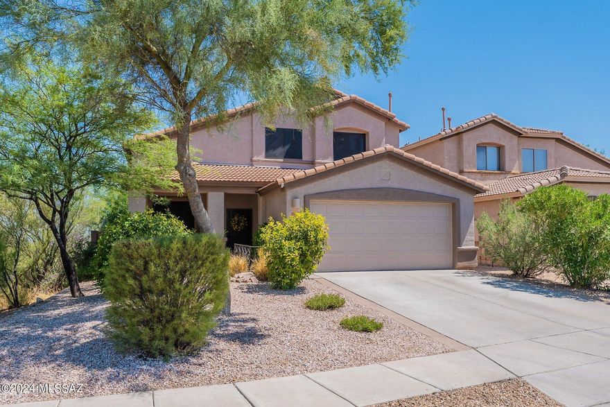 Location, location, location with impeccable views! This stunning 2-story home boasts breathtaking Rincon Mountain views and offers a perfect blend of comfort and elegance. With 3 spacious bedrooms, plus a versatile den, and 3 full bathrooms, there's plenty of room for everyone. The beautifully updated kitchen has entertainer's island with white rock backsplash, Corian countertops, black appliances, walk-in pantry and plenty of cabinet space. The kitchen opens up to great room concept living, perfect for entertaining! Downstairs has den, currently used as a bedroom, and half bath. Move your way up the beautiful stairs case, which overlooks the formal living room to the remaining bedrooms and bathrooms. Primary suite overlooks backyard and has STUNNING Rincon Mountain views. Enjoy a soak in the garden tub with equally gorgeous view. Once your squeaky clean, head over to the large walk-in closet with loads of storage! 2nd guest bedroom also has roomy walk-in closet as well! If the open-concept living isn't enough space for guests, take it outside to this gorgeous backyard that is a true oasis, perfect for entertaining as well. Extended paver patio is surrounded by low-care by lush vegetation that creates a serene, private and relaxing environment. The property is adjacent to wash area, and nothing behind the property except stunning mountain views, giving you only one adjacent neighbor! Don't miss your chance to own this exceptional property!