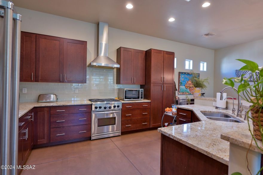 Newer 2015 construction home in Historic Sam Hughes Neighborhood one mile from the U of A Campus.  This spacious 4 bedroom/den home has many features you won't find in this area with 10 foot ceilings, 8 foot interior doors, open great room floor plan, skylights, energy star windows, built to TEP Energy Efficiency standards, Solar Water heater & grey water ready. You'll love your gourmet kitchen, adobe stained concrete floors, granite counters, primary suite with his & hers walk in closets & double sinks in the bathroom.  Remote control gated entrance to your driveway is   mesquite canopy lined which offers plenty of room for many parked cars. Huge extended patio for entertaining & low maintenance yard.  Close to Banner Hospital & Restaurants. Alarm, Reverse Osmosis & Soft water Systems.