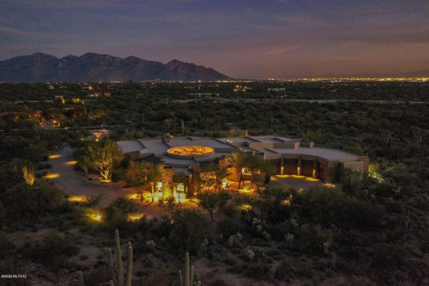 Looking for a great space to work from home? Incredible den/ofc w/wet bar in this architecturally stunning soft contemporary home welcomes you into the serenity of desert living. Panoramic mountain views in every direction! Located on Tucson's NW side in Marana, this unique property offers a southwest lifestyle coveted by many. A ''Lusso Home of Distinction'', this home was designed & quality built to blend w/the landscape. The result is very aesthetically pleasing. W/over 3,300 s/f of covered patio space, open the many patio doors & invite the outdoors in! The floor plan is especially suitable for entertaining. The guest rooms & guest house are spread out for privacy. Luxurious master suite feat. an extraordinary bath experience & private patio.The kitchen & butler's pantry are a cook's dream.  Wine room, 9 zone Sonos sound system, rock waterfall spills into the sparkling pool & spa, beautiful outdoor fountains. Custom outdoor kitchen.  Heated/cooled 2100 s/f 4 car garage w/finished floor, plenty of storage, Baldhead custom cabinets, workbench & lighting, Orenco septic system. Sunpower X-Series Solar Panels (X22-360) installed Jan 2020.  Too many things to list....come see for yourself!