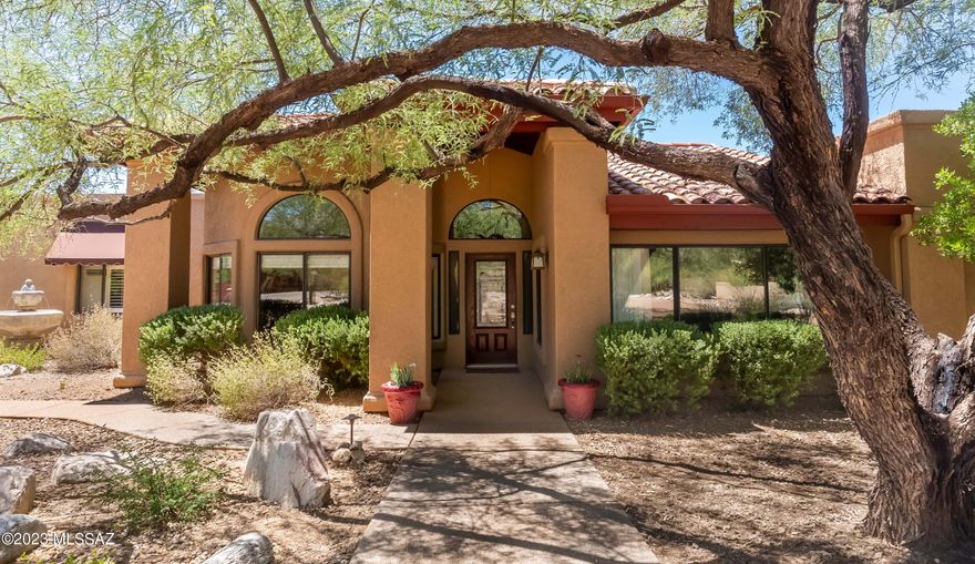 Welcome Home to this BEAUTIFUL property in the Tanque Verde Valley!  This 2977 sqft home on .9 acres features 5 spacious bedrooms, 3 full bathrooms, a 2 car garage, a 500+ sqft attached casita, and NO home owners association!  Mountain views in every direction, pool and spa in large, fenced backyard, and wide open space behind the home provide additional freedom and privacy.  Enjoy sunsets on your back porch's long, shaded patio, and follow the paved walking paths past your built-in BBQ, fruit-bearing citrus trees and firepit to watch horses behind your home in the pastures owned by the University of Arizona Ranch Management.  Mature trees provide shade over the lovely paved sidewalks and a fountain in front leading to your home's entrance, where the immaculately clean living space boasts high ceilings, open floorplan, all stainless appliances and island in kitchen, two unique living spaces, and inviting fireplace.   Spacious primary suite features additional cozy fireplace, large bathroom with separate shower and soaking tub, grand walk-in closet, and double sinks.  500+ sqft CASITA attached to the home, featuring kitchenette, bedroom, living space, and bathroom.  Three generous-sized guest bedrooms and bathroom in the back of home for additional family, visitors, office spaces, or flex rooms.  Water tank less than 6 years old!  Main house air conditioner less than 5 years old!  Carpet in all main house bedrooms less than 3 years old! Roof recoated 1 year ago and pool deck recently repainted!  All window coverings and appliances stay, including washer and dryer in laundry room!  Pride of ownership in this lovely property.  See it today before it is gone!