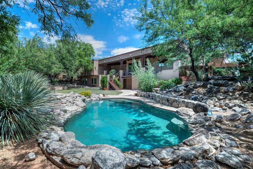 SWEEPING MOUNTAIN VISTAS & SUNSET VIEWS BOARDERING VENTANA CANYON GOLF COURSE. THIS PRIVATE 5 BR 5 BA AUTHENTIC SANTA FE WITH CEDAR CEILINGS AND VIGA BEAMS AWAIT YOU. FINELY CRAFTED LUXURY HOME NESTLED IN GATED CANYON VIEW ESTATES IN DISTRICT 16. THIS STUNNING HOME HAS A SPLIT FLOOR PLAN, VERY TASTEFUL MASTER SUITE WITH GAS BEEHIVE FIREPLACE, SUMPTUOUS BATH AND EXERCISE ROOM. THE AMAZING KITCHEN HAS 5 BURNER GAS STOVE TOP GRANITE COUNTERS CENTER ISLAND AND SOLID ALDER CABINETS. ALL NEW WINDOWS, 3 CAR GARAGE WITH GREAT STORAGE.THE BACKYARD HAS A LAGOON STYLE POOL AND SPA, BUILT IN GAS BBQ, BEEHIVE FIREPLACE & EXPANSIVE COVERED PATIO. WHETHER GATHERING TO ENTERTAIN FRIENDS & FAMILY OR CURLING UP TO ENJOY THE SPECTACULAR SURROUNDINGS AND SUNSETS, THIS REFUGE WILL EXCEED YOUR EXPECTATIONS