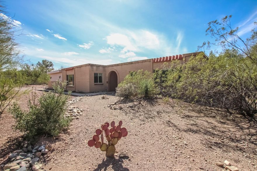 Nestled on over 1.03 acres, breathtaking mountain views and private setting await. Located in Tanque Verde School District.  This classic Territorial Style Home was recently updated with premium finishes. Spacious, open floor plan, cozy fireplace, neutral palette, beautiful tile floor, retro lighting, ceiling fans, and patio access from living room. Stunning updated kitchen with hickory cabinets. Features center island, premium granite counters, breakfast bar, black appliances, and wood cabinets. Generous size bedrooms, ample closets, and 2 upscale baths with granite counters. Enjoy the backyard with sparkling fenced pool, covered patio, grassy play area, and views! Will NOT last!