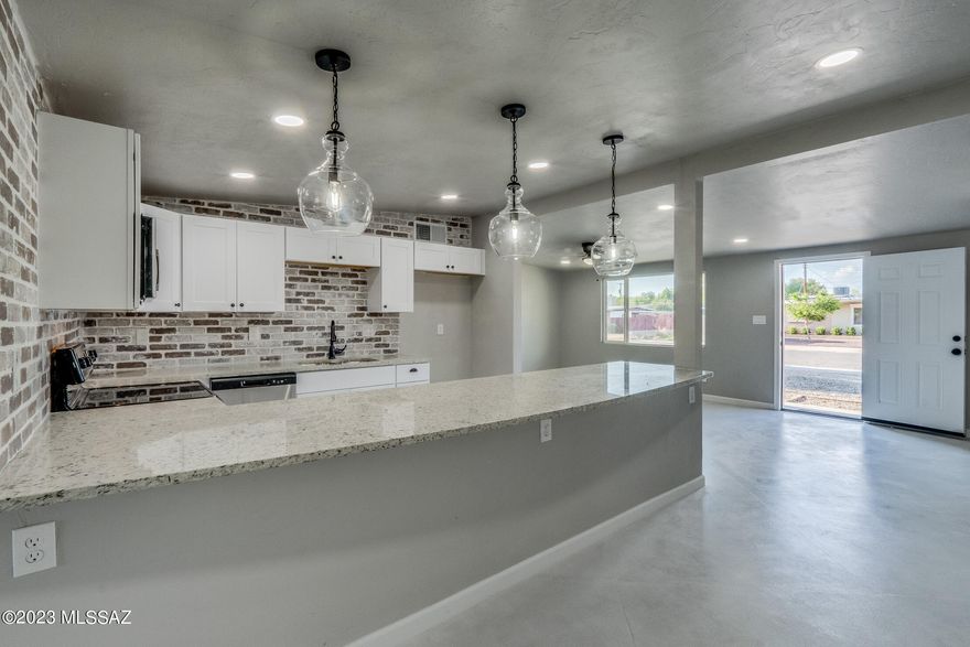 Range priced $310,000- $320,000. Absolutely gorgeous remodeled home in west central Tucson. This home shouts perfection from the moment you walk in the door. Be greeted by custom concrete floors that lead to an amazing new gourmet kitchen with granite counter tops. Stunning brick backsplash and all new lighting. New windows, HVAC and water heater. You will love the spa like bathrooms with custom surrounds and all new vanities and fixtures. Large backyard with block wall and just minutes from I-10. Seller is licensed to sell real estate in Arizona.