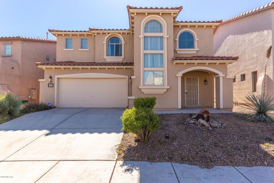 Gorgeous two story 3 bed/2.5 bath home with great curb appeal available in prestigious Rancho Sahuarita. Love life in this amazing lake community with beautiful parks, a pool and spa, athletic facilities, sports courts and more. Inside is immaculate. Impressive living and dining area features dramatic soaring ceilings, elegant pendant lighting and neutral paint tones. Wood floors in the living room and den. Inviting kitchen boasts plenty of cabinet and counter space, coordinating black appliances and a large pantry with a beautifully etched glass door. All bedrooms are upstairs, including the master with a private 3/4 en-suite. Low maintenance backyard offers a covered patio and is fully enclosed with block fencing, perfect for pets or play. This gem has it all. See it and make it yours.