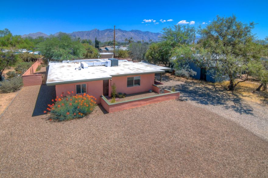 Range Priced-Seller will Accept/Counter Offers $300,000-315,000. Beautifully updated Central Tucson home near La Madera Park! Fantastic home features 3BR, 2BA and is fully updated throughout!  Gorgeous, well-appointed kitchen has white cabinets, ss appliances, quartz counters & fridge! Spacious master suite has a large walk-in closet, fully updated tub/shower and additional walk-in shower, dual sinks with quartz counters! Split bedroom plan features updated hall bath, extra closet, hall shelving & two large bedrooms! Huge laundry room! Outside you will love the covered patio facing the mountain views, .25 acre lot, storage shed, desert plantings & grass. Newer AC, water heater, updated lighting, ceiling fans & windows!  Near UA/BUMC, shops & restaurants! See the MATTERPORT 3D Virtual Tour!