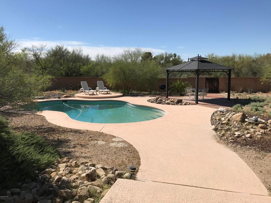 Lovely Ranch on over half an acre.  This home shows pride of ownership.   In addition to large living and family rooms there is a huge game room and a studio, both with extra storage.  The studio could be converted into a casita as it has seperate access.  Game room offers tons of natural light with five skylights that open for fresh air and that great indoor/outdoor feel.  The sparking pool and ramada are perfect for summer days and relaxing evenings. 18 inch neutral tile throughout, no carpet, indoor laundry, large walk in closet in master and RV pad in addition to attached two car garage. AND two newer HVAC units!