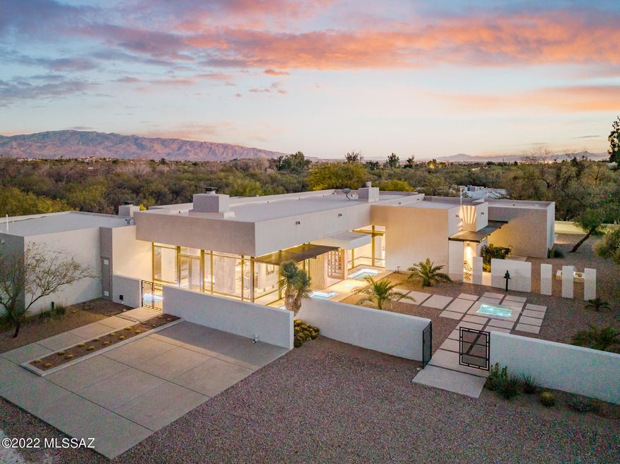 Breathtaking views surround this Robert Bacon designed contemporary masterpiece. Gated and private, sitting on 2.07 acres with Sabino Creek as your backdrop. Well thought out split floor plan with 4 bedrooms, 4 bathrooms and 4,636 Sq. Ft. of living space in the main house and 576 Sq. Ft. Guest House. Three fountains and a surrounding water feature envelop the home, creating a sleek and sophisticated exterior. Spaciousness throughout with an expansive Great Room with Living Room, Formal Dining area and Family Room just off the Kitchen. Immaculate imported Poggenpohl kitchen with incredible attention to detail. A walk-in pantry and stainless steel appliances, gas and induction cooktops and double oven complete this cook's kitchen. Each room has its own distinct awe-inspiring view that is created by 12-foot floor to ceiling Fleetwood windows. Fleetwood doors open to the resort style backyard with infinity pool and spa. The private Guest House is perfect for guests or your own Art Studio, complemented by a full bathroom and steam room. Located in District 16 and private horse stable & famed Canyon Ranch Resort are within walking distance. Each bedroom has en suite bathroom and private outdoor space. Very rarely does a home of this quality and magnitude come to the market.