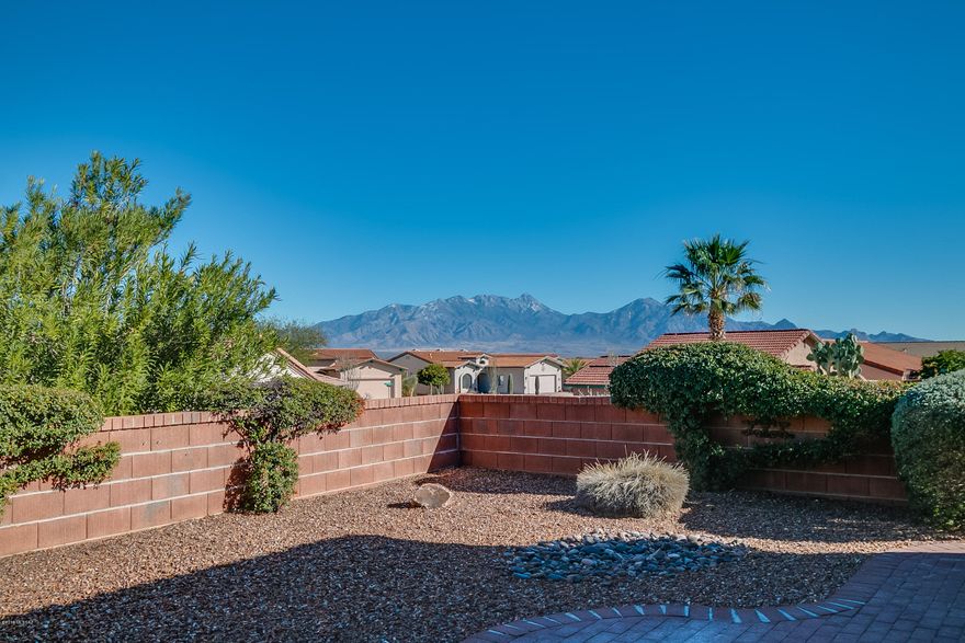 East-Facing Patio with great views of the Santa Rita Mountains! Nice curb appeal with crisp desert landscaping complete with a front courtyard. The San Miguel floor plan is just the right size with 1507 square feet; 2 BR; 2BA and large office/hobby area. Terrific size great room and plantation shutters throughout the home. The kitchen has an abundance of cabinets and a convenient breakfast bar too. A split bedroom arrangement with the master suite on the southeast side of the home. The screened Arizona room is sure to be a place where you will enjoy quiet time reading a book or conversing with friends! A very convenient location in the heart of Green Valley near the Las Campanas Recreation Center, Green Valley Library, churches, shopping and restaurants. A gem indeed!
