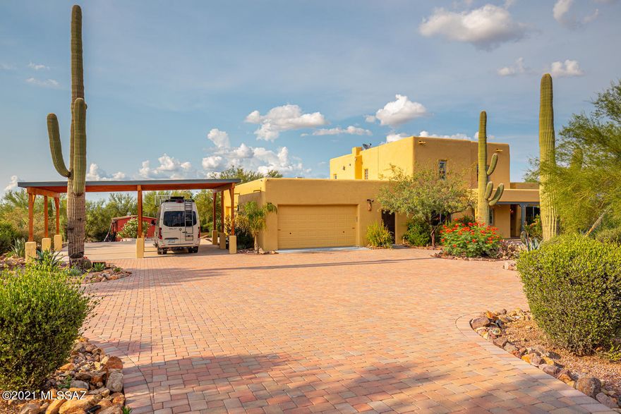 Beautiful estate in Tucson's West mountains sits on a large 4 acre lot w/360 views. This well built 4 BD/3 BA/3,011 Sq.Ft/4 car garage home is built of energy efficient Rastra block construction. A long driveway leads to a paver driveway & lush Sonoran Desert landscaping w/tons of Saguaros. Lower level floorplan offers a family room w/fireplace, living area off front entry, formal dining & guest bedroom & bath. Kitchen has plenty of cabinets, tile counters, stainless steel appliances, island w/breakfast bar & sink & casual dining area. Upper level has master suite, 2 guest bedrooms & bathroom. Master suite is spacious w/dual vanities, walk-in shower & large walk-in closet. Master suite has access to it's own balcony w/amazing views. Entertainers backyard offers a huge covered patio..... ....tons of pavers, lush landscaping & a sparkling & fenced pool. 4 car garage is massive w/plenty of room for your toys, boat or trucks & covered RV parking.  Amazing desert setting views, landscaping & privacy.