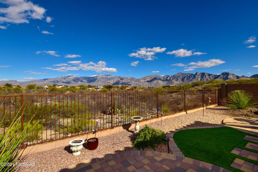 Beautiful Home with Stunning Unobstructed Catalina Mountain views on almost a quarter acre with no one behind or to the right side of property. Open floorplan with upgraded gourmet kitchen with large Island open to Greatroom. Split Bedroom with extra room in between. Professionally landscaped backyard to enjoy to gorgeous open desert with amazing views of the Catalina Mountains. 3 car garage too!