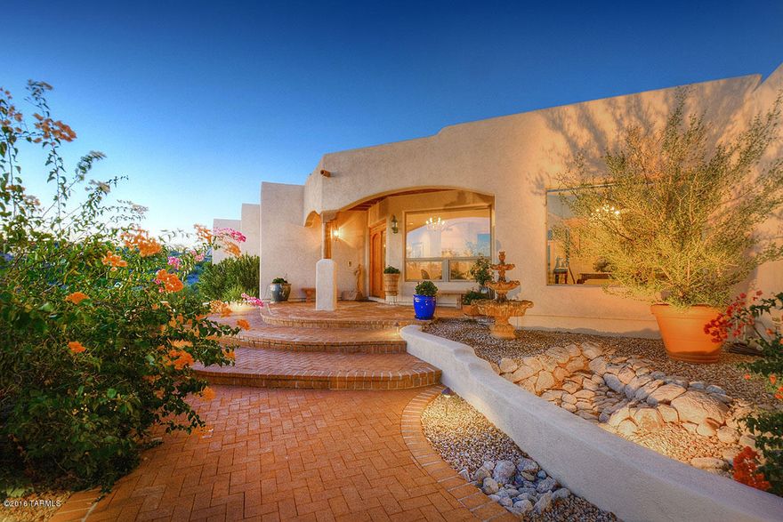 Spectacular City & Mountain Views from this premium elevated lot in Cimarron. This quality built Santa Fe home has 4 BR/3 BA with new exterior & interior paint. Enter thru the foyer with sitting area to the formal living room with custom fireplace and picture windows. Enjoy Tucson city lights from the elegant formal dining room. Open cook's kitchen has granite counters, new induction cook top & double ovens.
Cozy family room off kitchen has exposed wood beam ceiling with fireplace and built-in shelving. Spacious master bedroom with sitting area, fireplace, California closets, and luxurious master bath with jetted tub. Beautifully landscaped back yard features sparkling pool & spa, expansive covered patio and separate raised patio area for entertaining.