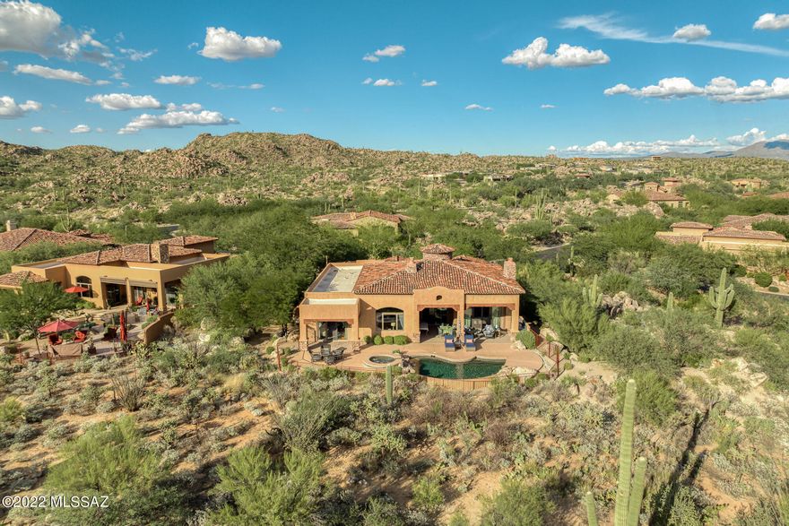Absolutely elegant and enchanting Stonegate original model home designed by Architect Barry Berkus. Delightful Mediterranean styling: wood beams, slate floors, wood doors & trim, crank windows, formal & informal living & dining areas w/2 gas Fpls, gourmet kitchen, built-in bar w/sink & wine fridge. This 3,423 SF residence offers 3BD, 3.5BA, Den/Rec Room, walk-in pantry, spacious laundry and 2-car garage. Large, deep covered south-facing patio w/built-in BBQ is accessed via 2 sets of sliding doors from the living room and augmented by self-cleaning pool & spa with rock waterfall next to a sitting area w/Catalina and desert views. Master suite includes private cov'd patio while guest wing has 2 more suites. Enjoy tasteful elegance, luxury and privacy in guard-gated Stone Canyon Club!