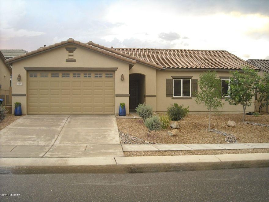 Beautiful well laid home with many delightful features! Large open kitchen with center island. Den creates more space for anything you want. Gorgeous flooring and other great features make this home move-in ready for you to add your own special touches! Ceiling fans throughout, and a gorgeous yard with mature trees and grass! Don't miss the great amenities of Rancho Sahuarita as well!