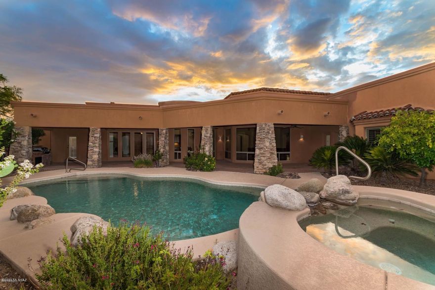 AMAZING Stone Canyon opportunity!  Best Value in this exclusive guard gated community. Gorgeous views of the Catalina Mountains and large spacious floor plan make this a buyer's dream. Perfect for entertaining with both casual and formal living spaces.  Cooks kitchen features plenty of beautiful granite counters - open to the large great room and a wall of floor to ceiling windows to take in the stunning views. Master Suite with his/hers closets, jetted tub and fabulous walk-in shower.  Natural travertine stone flooring throughout - no carpeting! Stacked stone  highlights and wood beamed ceilings! Spectacular views from the brick paver patio with pool & spa and built-in BBQ.  Upside potential for this fantastic home just waiting for your updates and personal touches!