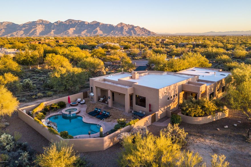 Sellers will accept or counter offers between $800,000-$835,000.  Looking for an escape? Look no further! This lovely, semi-custom contemporary home sited on 4.5 acres of natural desert offers 3319sf of living space and three separate private patios. With abundant outdoor space surrounded by fabulous Catalina/ Tortolita Mountain views, this home is a haven for relaxation and entertaining. As you arrive, you are greeted by a gorgeous, curving entry patio, complete with native desert plantings. Tall French doors add a sense of volume to the open-concept home and patios. Working from home doesn't get any better. Enjoy a sense of peace and tranquility from your morning coffee on the fireplace-warmed side patio, to unwinding at the end of the day in your backyard. Turn key option available. the salt water pool, relaxing spa, gas firepit and outdoor kitchen.