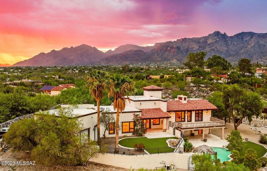 One of a kind estate nestled in the heart of the prestigious Catalina Foothills Estates neighborhood, this 5,039 sq ft, 5 bedroom, 4.5-bathroom home boasts some of the best unobstructed city and mountain views you will find. This Spanish Colonial masterpiece is a testament to high-end design and elegantly combines the best of timeless architecture with modern luxuries. 

Set on a sprawling 1.65 acre lot, which is entirely fenced in, this property offers both city water and a private well, providing the rare opportunity to create a lush oasis in the desert. The estate is also a horse-friendly property, with no HOA constraints, and allows for a home business if desired, making it a unique gem in the Catalina Foothills.

Walking into the kitchen, you are welcomed by an oversized Wolf gas range with a flat griddle, a Sub-Zero refrigerator and freezer, & chiseled-edge Brazilian granite countertops. The European Versailles cathedral natural stone flooring, vintage carved stone fireplaces from South America, and the solid knotted alder doors, are just a few of finishes that impressively showcase the attention to detail and quality. The floor plan is great for multi-generational living with all 5 bedrooms having access to an en-suite bathroom.

The spacious five-car garage is a car collector's dream, boasting approximately 1,200 sq ft and an RV garage door. The spacious garage height offers the potential for future car lift and storage of up to 10 vehicles. 

The exterior is just as impressive as the interior. A huge entertainer's backyard awaits, complete with a heated pool featuring swim-up bar seating, an outdoor kitchen with built in BBQ and prep sink, and multiple patios and balconies that can accommodate the largest of gatherings. The property is adorned with mature landscaping, including citrus trees and specimen cactus, providing a sense of tranquility.

Enjoy the benefits of a prime location, high-end finishes, and the serenity of your own private oasis. Truly a special property that exemplifies the best of luxury living in Tucson.