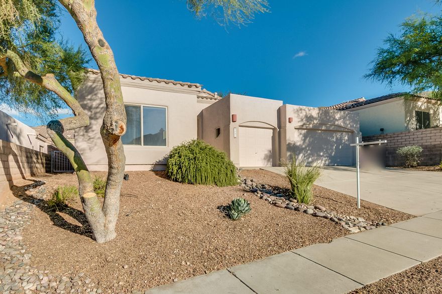 DESIGN YOUR OWN BACKYARD OASIS WITH MONEY SAVED AT THIS GREATLY REDUCED PRICE! This gated community, home to Arizona National Golf Club, is move-in ready and waiting for YOU!  The spacious 2300 sq.ft floor plan is open and bright. The large kitchen with abundant storage overlooks the family room that features a corner built-in area. A fireplace graces the living room. It has a split bedroom plan with 3 bedrooms and a den/office, 3 baths, and a 3-car garage. Numerous ceiling fans. Interior newly painted. New carpet. A/C installed 6/2016. A water harvesting system is installed in backyard.