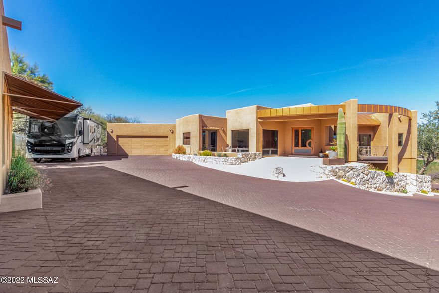 If you are looking for a peaceful retreat this luxurious home has your needs covered! Located in Oro Valley Heights! Delightful curb appeal with front patio for you to relax in! Immaculate interior has fresh neutral palette, decorative light fixtures, travertine tile flooring, & several glass sliding-doors leading outside. Two-way fireplace separates living areas. Gourmet eat-in kitchen is equipped w/SS appliances, cabinets w/crown moulding, stylish tile backsplash, huge island w/breakfast bar, walk-in pantry, wet-bar, & granite counters. Primary retreat showcases huge windows w/incredible views, double-door entry, romantic fireplace, patio access, walk-in closet, and a deluxe ensuite w/mosaic backsplash in both sinks & a lavish tub you'll love. Finished basement. Detached guest house has a kitchen & bathroom. Unwind in this amazing backyard w/built-in BBQ, shimmering pool & spa, exterior fireplace, & fantastic mountain views. What are you waiting for? Make this gem yours now!