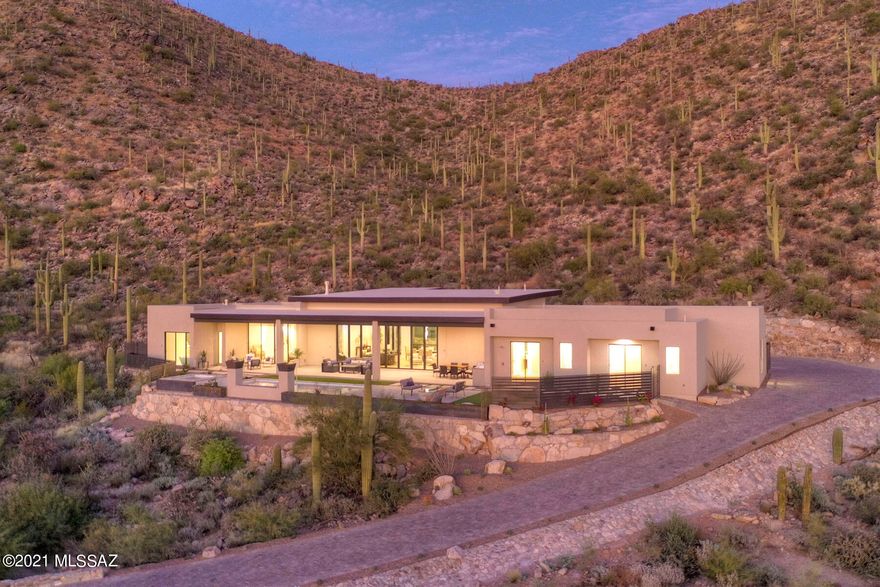 JUST COMPLETED!!!
''WOW'' is the first word out of everyone's mouth when they see the amazing setting, quality finishes, & open and expansive layout of this spectacular home. This newly constructed home is now complete and ready for viewing! It sits up high on a cul-de-sac in the exclusive gated Gallery Canyon Community of only 15 estate lots. Cobblestone streets lead you up to sweeping valley views and a saguaro studded canyon. Very Private with over 50 acres of adjacent natural open space. Check out the walls of glass everywhere you look. Split floor plan. No interior steps. This is an entertainer's paradise with expansive outdoor living areas. Walking distance to the Gallery Country Club restaurant and golf facilities. If you are looking for something special, this is it! Engineered hardwood flooring and porcelain tile. Firepit, pool fire feature, and water spillways are amazing. Taj mahal quartzite countertops in the kitchen with waterfall sides on the island. Luxury high end appliance package including Sub-Zero fridge and 60" Wolf Range. Huge walk in pantry off kitchen. Elevated putting green / additional patio for entertaining in front. 24' Panoramic sliding glass door system that fully opens to the rear yard covered patio. Impressive 10' high metal and glass single pivot entry door. Amazing outdoor kitchen. Come see the best!