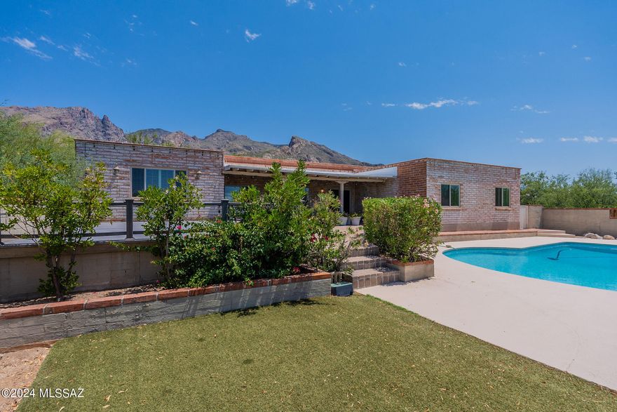 Welcome to your new home in Coronado Foothills Estates! This burnt adobe property boasts spectacular mountain views & offers 2,418 square feet of living space on a 0.73-acre lot. Enjoy the tranquility of your landscaped courtyard with mature vegetation, or take a dip in the pool. Inside, you'll find 5 bedrooms & 2 ½ baths. The living room features a cozy fireplace & ceramic tile floors, perfect for relaxing evenings. The bright, open kitchen with tile countertops, double sink, barstool seating, and ceramic tile flooring opens to the family room. The separate dining room provides access to the back porch, where you can enjoy your morning coffee or evening meals. Additional amenities include a large primary bedroom with backyard access, a patio, and covered porch off the pool. Welcome Home!