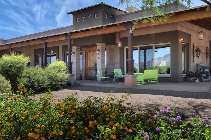 25 ACRE TORTOLITA MOUNTAIN RANCH! Privacy, unobstructed views of the Catalina and Tortolita Mountains, fabulous full horse facilities and a gorgeous ranch style custom home sit among the mature mesquites in a quiet NW neighborhood. An architect/builder's own property, this energy efficient 3 BR, all with walk in closets and 3 en-suite travertine baths plus a powder room boast a great room concept plan. It has a beautiful kitchen with granite, stainless steel appliances and alder wood cabinets. An awesome Tortolita Mountain rock fireplace is the centerpiece of the spacious living room. There is also a grand dining room, den/office, laundry room and oversized 2 car garage with 2 storage rooms. The home is built with strong Integra Masonry construction.  (SEE SUPPLEMENT) The most beautiful colored scored concrete floors flow throughout the home. Mud adobe, distressed French limestone, high ceilings and huge windows are only some of the exquisite artistic touches from the architect. There are over 6,085 square feet under roof including the expansive porches. They are incredible with over 2,100 square feet of enticing space with metal roofing and rusted steel columns which add an appealing rustic flair to the home. It is a true entertainer's delight inside and out and all within minutes of the finest amenities. 
The rare, extensive horse facilities include a full size lighted 150' X 300' arena, a second 75' X 100' arena, 2 round pens, a MD 18 stall barn all with outside pipe corrals, a large covered, lighted ramada with a masonry fireplace, a hay barn, covered and lighted wash rack, covered farrier/vet structure, an office, 3 half baths for riders and guests, full RV hookup, tack rooms, one mile of trails on the property and it is zoned for a commercial boarding facility. 
There are many new and updated amenities on the property including new HVAC units, a water softener, water heater, roof coating, electric gate controls and more. 
This ranch is a marvelous, unique, private ensemble of elegant comfort and professional horse facilities that anyone, and equestrians of all levels, would be thrilled to call home. Arrange a private showing today.