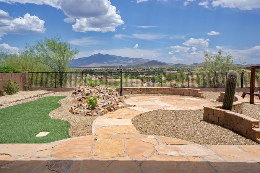 Charming and well-maintained move-in-ready home in the award-winning Vail School District. Check out the amazing views of Rincon and Catalina Mountains, and enjoy the fabulous Tucson sunsets from the patio in your very own beautiful low-care backyard. As you open the front door, you'll see views from every room in this 3 bedroom/2 bathroom (plus den) open floor plan home. The eat-in kitchen feels spacious and open and features an island, breakfast bar, and a new gas stove/oven. The Master Bedroom has a walk-in closet and spacious bathroom with double sinks, separate shower, and a garden tub with incredible views of the mountains. The laundry room is conveniently located and features built-in cabinets. The extra deep 2-car garage also has convenient built-in cabinets.