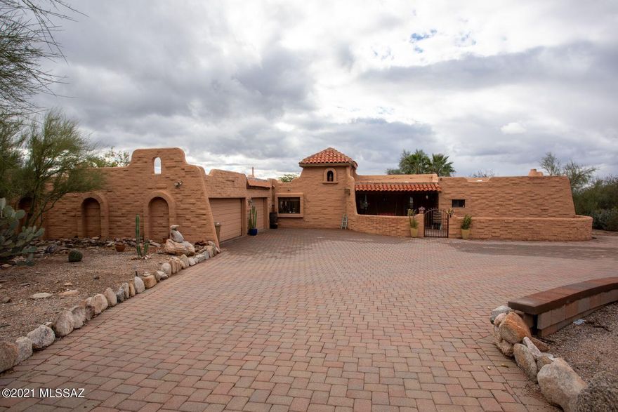 Your private oasis awaits you in the highly sought after Catalina Foothills Estates 9.  At the end of this cul-de-sac a spacious brick paver circular driveway greets this 2,911 sf Spanish Mission style estate home featuring three bedrooms/three bathrooms with an open floor plan and warm natural lighting.  French doors open to a Saltillo-tiled wrap around patio with built-in outdoor kitchen and a gas/wood burning fireplace.   Situated on an acre+, the backyard paradise welcomes your family and guests with lush mature landscaping, fruit trees, and exotic plantings.  Enjoy majestic Santa Catalinas mountains views and colorful sunsets from the N/S facing home..  This quaint, private neighborhood reflects pride-of-ownership throughout, with paved streets, and is resident-managed with low HO