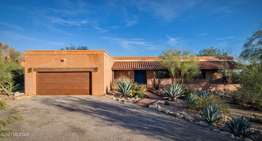 Sellers shall entertain offers between $750,000 - $775,000. Panoramic views of mountains, city, sunrise, and sunset set on a secluded lot just north of La Encantada Shopping Center in highly desirable ''Foothills''.  Luxuriously remodeled ranch style home with a mid-century vibe.  Open, light and bright with a huge expanse of windows to let the outside in.  A dream kitchen includes high-end granite, white newer cabinets, Samsung & Bosch appliances, & tons of storage.  Custom finishes throughout.  Brick wall fireplace. Newer lighting fixtures, ceiling fans, and bamboo flooring. A beautiful mix of Classic & Contemporary. Covered back patio faces East w/million dollar views.   Circle drive.  Low care desert front and back yards.  Room for a pool on north side.  Storage !