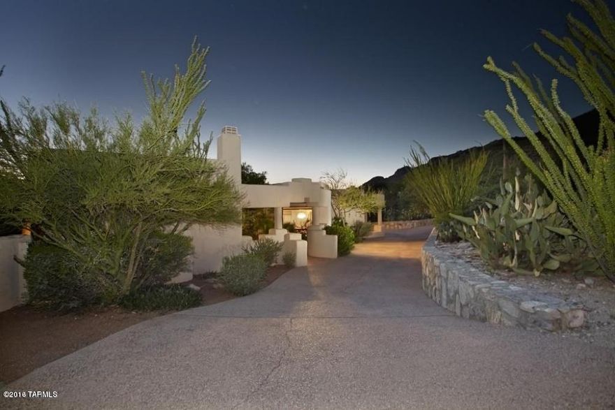 Location, location, location! Southwest contemporary home is on one of Cobblestone's finest view lots directly across from Tucson's most expensive home, Campbell Cliffs. Situated to capture stunning city views, this property features 4 bedrooms, 3 full bathrooms, high coved ceilings, walls of windows & expansive patios (over 1200sf) to relax outdoors by the beautiful pebble tec pool. Light & bright, the kitchen has an eat-in breakfast nook w/ mtn views & is open to the family room w/ fireplace. Spacious master suite w/ fireplace has a garden tub & large walk-in closet. 3car garage, circular drive & unlimited potential to make this home a true showplace.