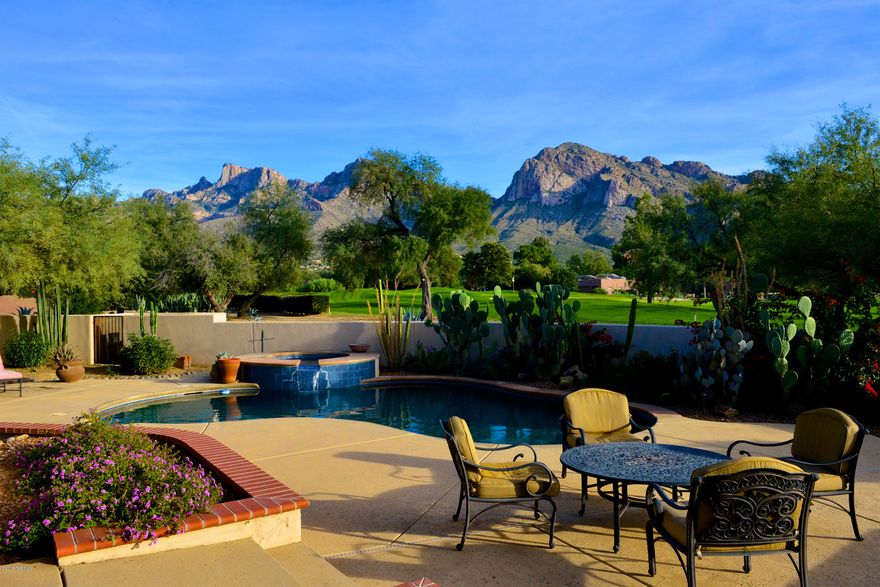 Opportunity Knocks! Custom home built in 2004 on premium golf course lot in the exclusive 3rd Fairway of OVCC! 3134sf with east-facing backyard Pusch Ridge views and sits adjacent to the 3rd green. Pebble tec pool & spa, 1500+ sf of covered patio with outdoor fireplace. Spacious kitchen with granite counters, butcher block island, hi-end SS appls and alder cabinets. Great room has wood beam ceiling and wall of windows to capture pool & mountain views. Split floor plan w/private master suite, den(or 4th BR) and 3/4 powder bath on one side of home; 2 BRs and jack-n-jill bath on the other. Paver/circle drive & 3.5+ car garage, private carts ok at OVCC. Fabulous home for those who want luxury desert living & country club lifestyle. Seller will pay one-time initiation fee for buyer membership!