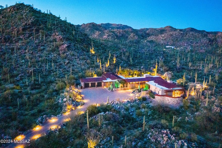 Stunning Southwest Contemporary home on over 4 acres.  Enjoy the Private living in exclusive Saguaro Ranch guard gated community.  Travel through the private tunnel and ranch gates to this gorgeous piece of the Sonoran desert.  This home is filled with the finest of finishings and luxury living.  The kitchen is a Chef's dream with Subzero Refrigerator, Bertazzoni Range, Wolf Warming Drawer, 3 dishwashers.  Primary bedroom includes a full morning kitchen with fridge, micro and dishwasher. Be 'Wowed' by the private spa on the bdrm patio with breathtaking views. Ensuite with huge closet, walk-in shower, tub and 2 water closets. The outside oasis includes beautiful pool and patio, firepit perched high for 360 views and the most amazing absolutely gorgeous outdoor kitchen!! No expense was spared in this recent remodel! Every detail is included right down to the beer tap and pizza oven. Perfect for entertaining or a relaxing night home!  3 car garage has 2 mini splits, air filtration and washer/dryer.  Home automation with URC audio/visual system.  This home offers the utmost in luxury living, privacy and desert beauty.