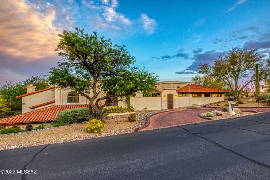 Seller will accept or counter offers between $1,395,000-$1,445,000. Welcome to this La Paloma Ridge Estates custom home, situated on a premium corner lot, it's a buyers dream. Walk through the courtyard and enter through the custom double doors and you will see no detail was spared. This stunning open concept, split floor plan has windows that line the back perimeter looking out to the gorgeous city lights. Hickory hardwood floors throughout. Newly remodeled eat in kitchen, featuring knotty alder cabinets, ss appliances, double thick chiseled edge granite island countertop, with additional seating at the island. Enjoy Catalina Mountain View's from the comfort of your couch in the family room. Owners suite is a must see with private sitting area and fireplace. The master bath will leave you feeling like you're at the spa with its luxurious Taj Mahal granite, 2 large walk in closets, free standing tub and separate walk in shower. Skylights throughout the home bring in natural light. Storage galore throughout the home. Bonus room with mini kitchen and full bath. Step foot outside and you're ready for anything. Entertain with the built in Kitchen, have a day at the park with over 1500sf of premium American Turf with pet deodorizer, or lounge by the travertine surround pool and spa.  Commercial grade misting system runs perimeter of back patio, so those HOT days won't be an issue. Enjoy your evenings relaxing on the full length covered patios and let the breathtaking views awe you. (See additional list of additional upgrades in documents.)