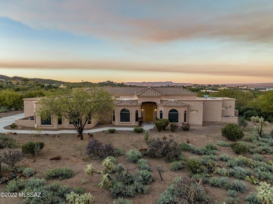 Amazing custom home in the Beautiful gated community of Saguaro Cliffs. Offering stunning panoramic views of Tucson Mountains, this home is an entertainer's dream! Nestled on over two acres of land, this home is sure to impress. Featuring a private driveway and large four car garage, plenty of room for all your cars/toys. Upon entering you are greeted with a striking foyer and sitting room. Designer touches and natural lighting throughout! The kitchen is a chef's dream. With new stainless-steel appliances, granite countertops, gas range and oversized island, this kitchen was built for entertaining. For the wine connoisseur, this home offers a thousand bottle wine cellar, a must see. The state-of-the-art theater room is rare and exceptional. The master retreat offers a dual sided fireplace, generously sized master closet, marble flooring throughout and private access to your backyard oasis. Privacy at its best! The expansive backyard offers a heated pool, with multiple seating areas, and outdoor kitchen. Your opportunity to own a rare and hard to find home on such a magnificent view lot is here.