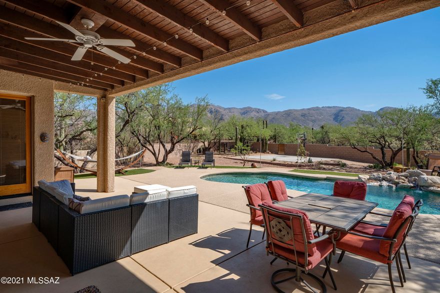 You'll love the amazing privacy & views from this custom home on the edge of town. The patio & pool offer wonderful views of the Catalinas & surrounding acre of desert with over 50 saguaros. This 3300 sf home includes an office & game room, but the great room, with its sky-high wood beamed ceiling & floor to ceiling beehive fireplace, is the true centerpiece. Kitchen features high quality appliances, soft close drawers & pull out shelves, built-in planning desk, pantry & granite counters. Plantation shutters on front windows; 5th bedroom has french doors to private patio and would be super guest or in-law suite. Roof re-coating + new AC to be installed by end of June. See Features and Benefits in Docs. Owner is a licensed Realtor 
in Arizona