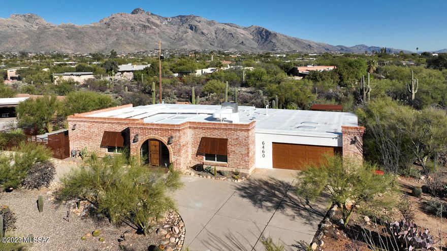 Completely renovated and meticulously curated by professional design company, Brick+Linen, this classic territorial w/fantastic mountain views has all the updates you could possibly desire while retaining its original charm & character! Grtrm features walls of windows & a cozy beehive FP. Stunning kitchen showcases a butcher block island, SS appl incl a 6-burner Cosmo gas range & wine fridge, matte granite counters & tons of storage. Bkyd features a sleek pool w/a baja shelf for lounging, spa, large covered patio, sep side yard w/pergola & beautiful landscaping. Gorgeous primary suite w/dual sinks & lg walk in shower. Work from home in the lovely ofc w/built-in desks & storage. Powder room for your guests, 2 add'l bdrms and a full bath. 2-C Gar, plumbing and electric have been redone!